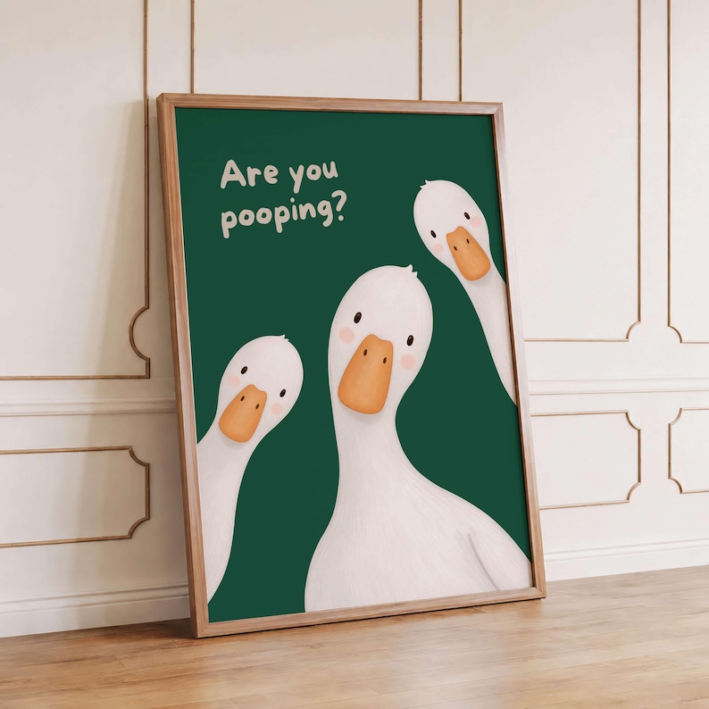 May include: A framed wall art print featuring three white geese with orange beaks against a dark green background. The text "Are you pooping?" is printed in a light cream color in the upper left corner of the rectangular vertical poster.