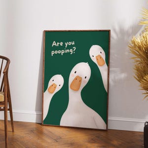May include: A rectangular wall art print featuring three white ducks with orange beaks against a solid dark green background. The text "Are you pooping?" is printed in a light-colored, rounded font in the upper left corner of the artwork.