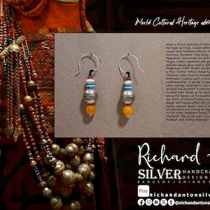 May include: Handcrafted silver earrings with Burmese pink ruby rondelle beads, turquoise glass, and yellow agate melon-carved beads. The earrings are handmade in Thailand and feature a unique design.