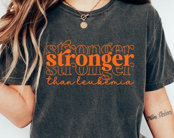 May include: A dark gray t-shirt with the text "stronger stronger than leukemia" in orange.