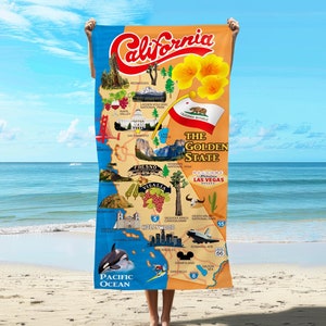 May include: A colorful map of California with illustrations of landmarks and cities. The map is on a beach towel with the words "The Golden State" and "Welcome to Paradise Las Vegas" printed on it.