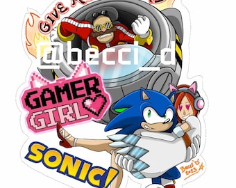 May include: A blue and white cartoon character, Sonic, is holding a pink-haired female character with a headset and cat ears. The female character is wearing a white dress with a pink heart on it. The text "Gamer Girl" is in pink pixelated letters. The text "Sonic!" is in blue and yellow. The text "Give Me Back My" is in red and yellow. The text "@beccld" is in black. The text "Becci's 2023" is in orange.