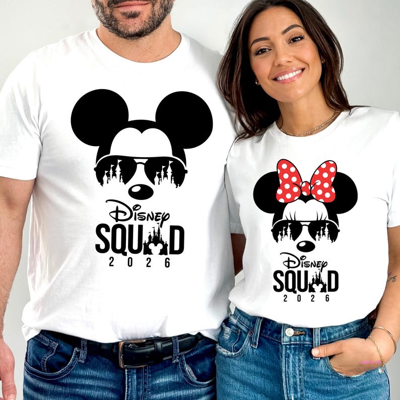 May include: White t-shirts featuring Mickey and Minnie Mouse designs. Mickey wears sunglasses and a castle silhouette, while Minnie has a red polka-dot bow. The text "Disney Squad 2026" is printed below the characters.