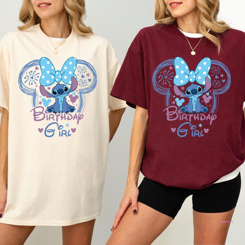 May include: Two t-shirts, one cream and one burgundy, featuring a cartoon character design. The design includes a blue character with a polka-dot bow, surrounded by a Mickey Mouse-shaped outline and the words "Birthday Girl."