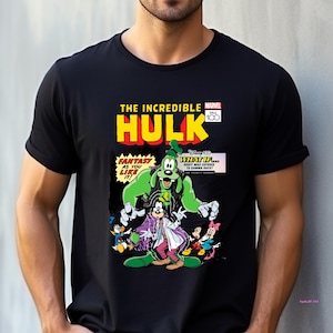 May include: Black t-shirt featuring a comic book-style graphic. The design includes the text "THE INCREDIBLE HULK" and "MARVEL 100". The graphic depicts a green Hulk-Goofy hybrid with other Disney characters.