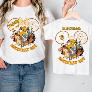 May include: White t-shirts with a Lion King theme. One shirt says "Mom of the Birthday Boy" and the other says "Rechal 3 Birthday Boy". Both shirts feature Simba and other characters from the movie.