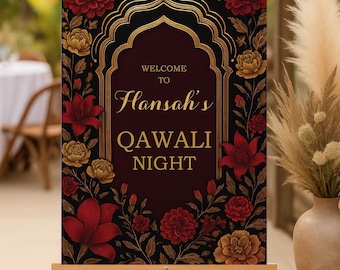 May include: A wooden easel displays a sign with the words "WELCOME TO Hansah's QAWALI NIGHT" in gold script. The sign features a dark red background with a gold arched frame and floral accents in red and gold.