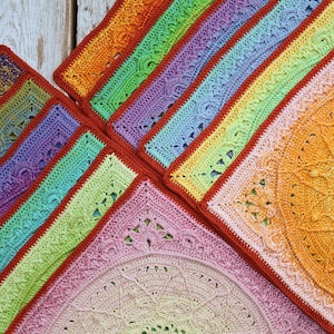 May include: A rainbow crochet blanket with a variety of colors and textures. The blanket is made up of multiple squares, each with a different design. The squares are joined together with a red border.