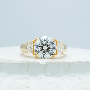Round Brilliant Cut Three Stone Ring – Yellow Gold Trillion Side Diamond Engagement Ring