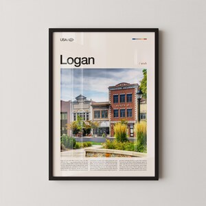 May include: Framed print featuring a photograph of Logan, Utah, with the text "Logan" and "USA / Utah." The image showcases historic buildings, a park, and the text "Plaza 45." The print is in a black frame.