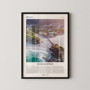 May include: Framed print featuring a coastal aerial view of Florianopolis, Brazil. The image showcases a beach with turquoise waters, a bridge, and a town nestled along the shore. The print includes the text "Florianopolis" and additional descriptive text.
