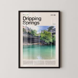 May include: Framed art print featuring a scenic view of Dripping Springs, Texas, with a turquoise lake and waterfall. The print includes the text "Dripping Springs" in a bold font, with "USA / texas" below. The image is set in a black frame.