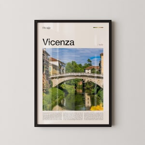May include: Framed print featuring a photograph of Vicenza, Italy, with a stone bridge over a river. The print has the word "Vicenza" in large text at the top, with the country name below. The image is in a black frame.