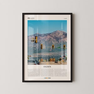 May include: Framed print featuring a scenic view of Ogden, Utah, USA. The image showcases a mountain range under a clear blue sky, with traffic lights and a road in the foreground. The word "OGDEN" is prominently displayed.