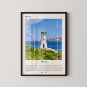 May include: Framed print of a white lighthouse with a green top, set against a blue sea and sky. The word "PALAU" is displayed below the image, with text beneath it. The frame is black.