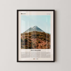May include: Framed print depicting Pico Island, Portugal. The photograph shows a snow-covered mountain dominating a landscape of brown and green vegetation against a clear blue sky. The text "PICO ISLAND" is visible at the bottom of the print.