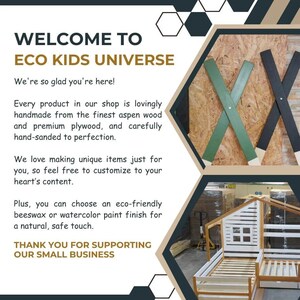 May include: Welcome to Eco Kids Universe, a shop that makes unique, handcrafted wooden furniture for children. The image shows a white wooden bed frame in the shape of a house, with a green and black wooden X design in the background.