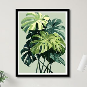 May include: A framed print of a green and white tropical plant with large leaves. The print is hanging on a white wall above a desk with a black chair and a lamp.