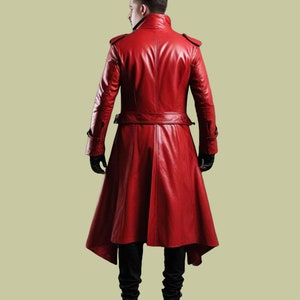 May include: A long red leather coat with a high collar and a belt. The coat has a long, flowing hemline and is made of a soft, supple leather.