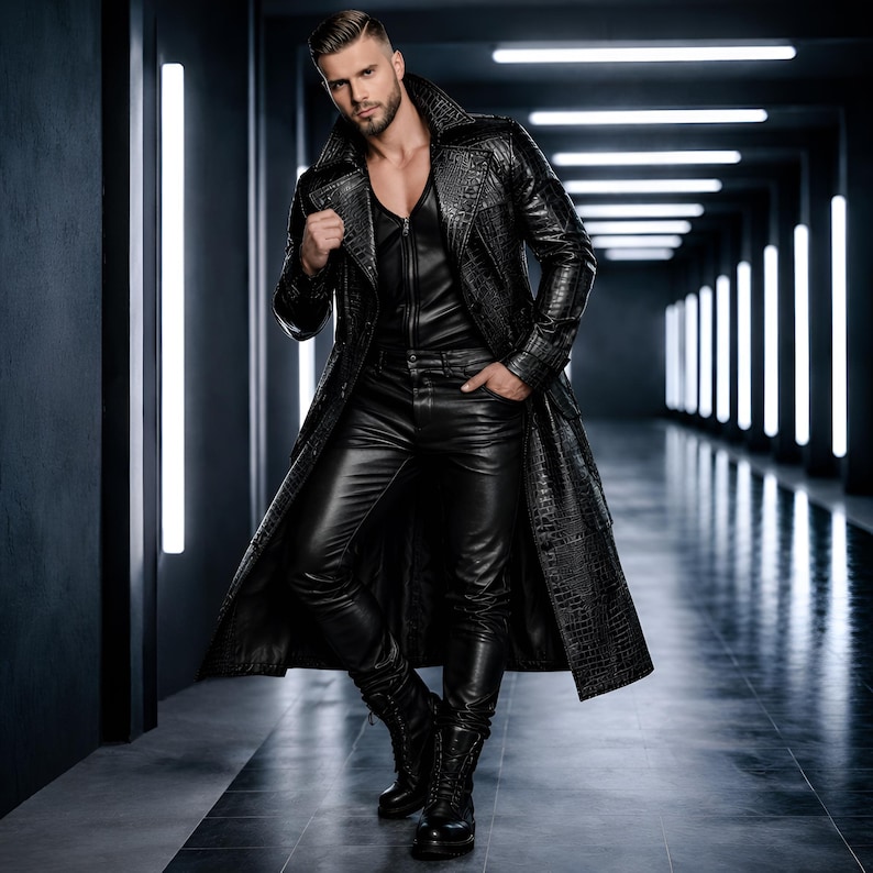 May include: A person in a black leather outfit, including a long, textured coat with a crocodile skin pattern, a vest, trousers, and boots. The background is a dark hallway with vertical lights. The overall look is sleek and stylish.