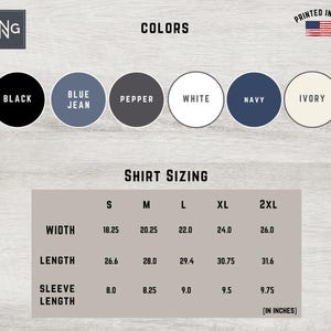 May include: Shirt sizing chart with measurements in inches for width, length, and sleeve length. Sizes include S, M, L, XL, and 2XL. Colors available are black, blue jean, pepper, white, navy, and ivory.