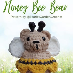 May include: A crocheted Honey Bee Bear plushie with a tan body, black antennae, and white wings. The bear wears a yellow and black striped skirt. Text at the top reads "HELLO Honey Bee Bear" and "Pattern by @ScarletGardenCrochet".