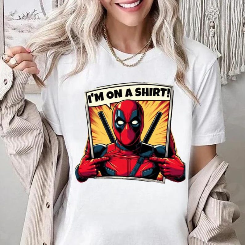 May include: White t-shirt featuring a comic book style graphic print of Deadpool. The text "I'm on a shirt!" is in a speech bubble above Deadpool's head.