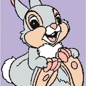 May include: A cartoon illustration of a smiling grey rabbit with large eyes, pink ears, and peach-coloured paws. The rabbit is sitting and has a fluffy white tail. The background is a light purple colour.
