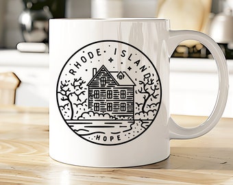 May include: White ceramic mug with a black line drawing of a house, trees, and water. The text "Rhode Island" and "Hope" are also included in the design.