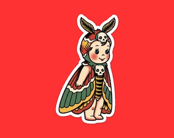 May include: A sticker featuring a vintage-style illustration of a doll with moth wings. The doll has a skull on its head and chest, with red, green, and yellow wings. The background is a solid red.