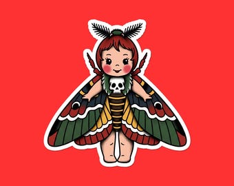 May include: A sticker featuring a cartoon moth-like figure with a child's face, red hair, and a skull on its chest. The moth's wings are detailed with red, green, black, and yellow patterns. The background is a solid red.