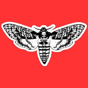 May include: Black and white illustration of a death's-head hawkmoth with a skull-like pattern on its wings.