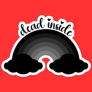 May include: A black and white rainbow sticker with the text "dead inside" and two small hearts above the text.