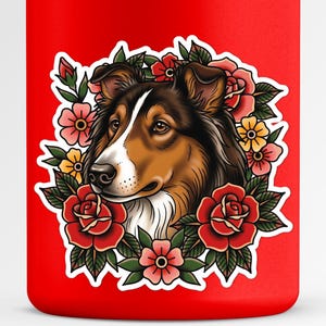 May include: A red tumbler featuring a detailed illustration of a dog's head surrounded by a floral wreath. The dog has brown, black, and white fur, with a white muzzle. The flowers are red, pink, and yellow.