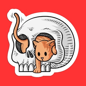 K&ouml;nnte beinhalten: Ein Aufkleber mit einer Cartoon-Illustration eines Katzenkopfes, der aus einem Sch&auml;del schaut. Die Katze ist orange und wei&szlig;, und der Sch&auml;del ist wei&szlig; mit schwarzen Details.
