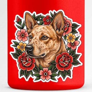 May include: A red tumbler with a detailed illustration of a dog's head encircled by a floral wreath. The dog has brown fur with spots, and the flowers are red, pink, and yellow.