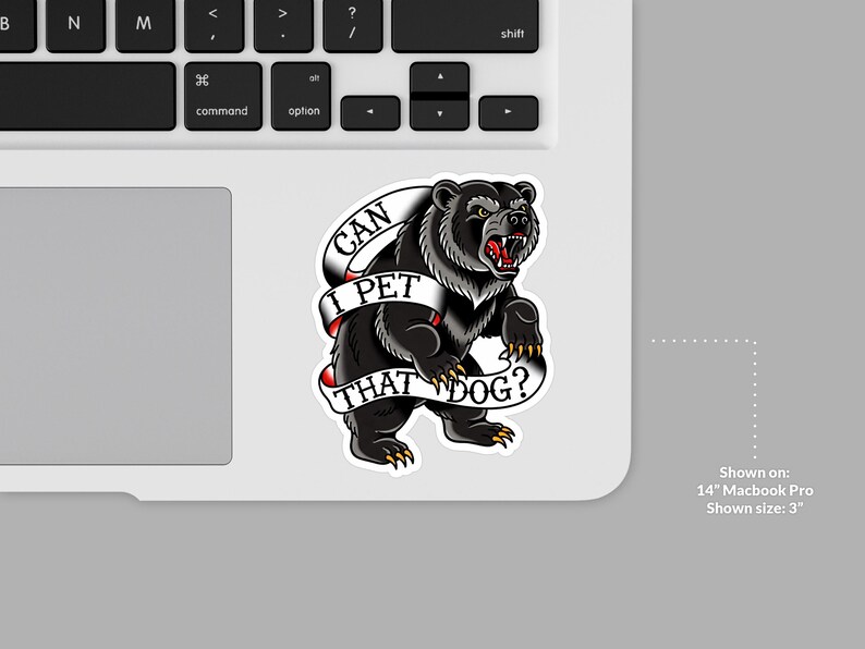 May include: A black bear sticker with the text "CAN I PET THAT DOG?" on a white banner. The bear is snarling, with its mouth open, and is on a laptop. The sticker is approximately 3 inches in size.