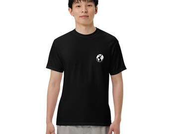 May include: Black t-shirt with a small white graphic of a globe on the left chest. The t-shirt is short-sleeved and has a crew neck. The person is wearing light gray cargo pants.