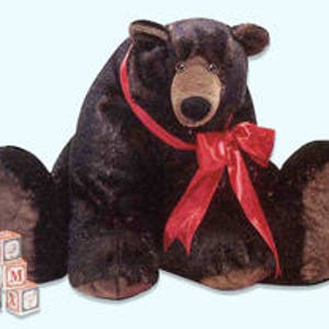 May include: Large brown plush bear with a red bow sitting on a white background. The bear has a brown nose and black eyes.
