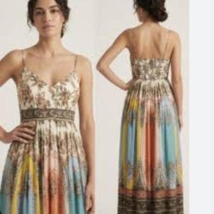 May include: A long, flowing dress with a floral bodice and a patterned skirt. The dress features thin straps, a V-neckline, and a fitted waist. The skirt showcases vertical stripes in shades of blue, yellow, and orange, with a detailed border.
