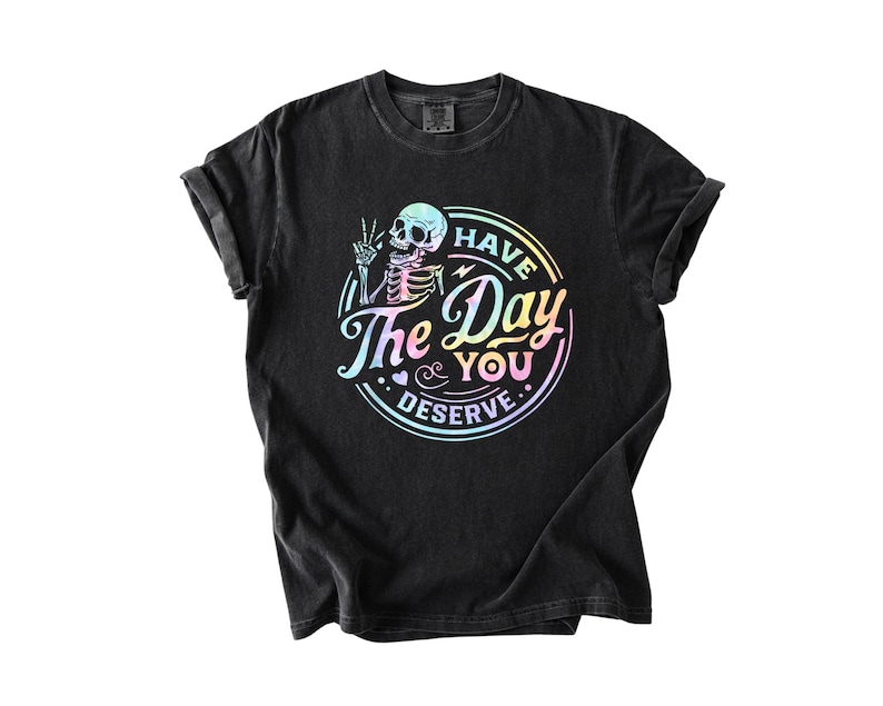May include: Black t-shirt with a rainbow-colored graphic of a skeleton with the text "Have the Day You Deserve."