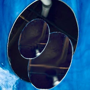 May include: Two round, black, reflective mirrors, one slightly larger than the other, are nested inside each other. The mirrors are set against a blue background.