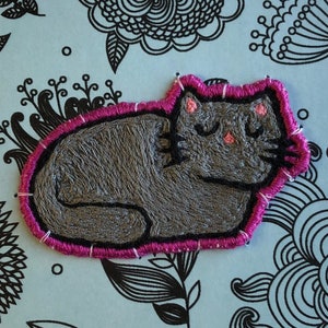May include: Thank you card with a gray embroidered cat sleeping on a blue background with black floral designs. The card has the text "paperandsewing@etsy" at the bottom.