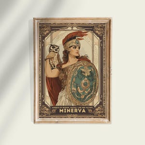May include: Framed print featuring Minerva, the Roman goddess of wisdom and strategic warfare. She is depicted with an owl, shield, and helmet. The artwork has a vintage style with the text "MINERVA" and "Goddess of Wisdom, Justice, Law and Victory".