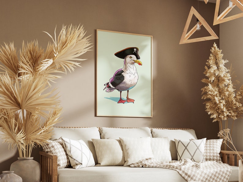 May include: A framed illustration of a seagull wearing a pirate hat with a skull and crossbones design. The seagull is standing on a light blue background.
