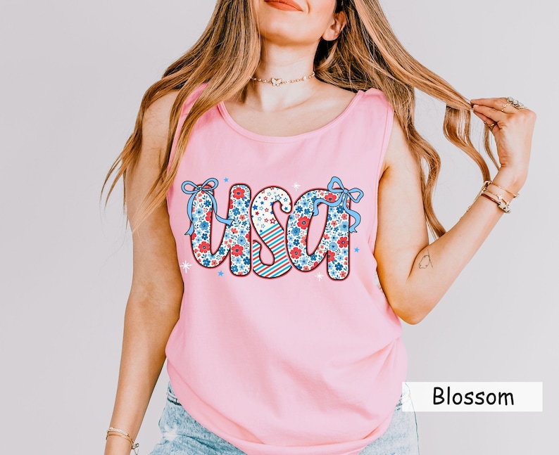 Pink Comfort Colors USA tank with red white and blue floral print. Perfect 4th of July shirt for women, styled for summer parties, patriotic events, and casual Americana outfits. Great for a cute and festive July Fourth tank look.
