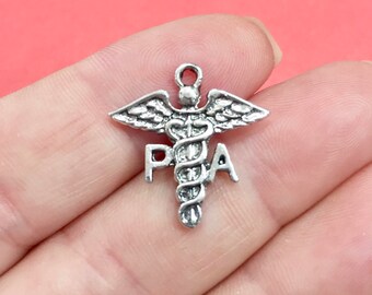 May include: Silver charm with a medical caduceus symbol and the letters "PA" on either side.