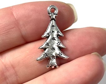 May include: Silver-toned Christmas tree charm with a star on top and stars embossed on the surface.