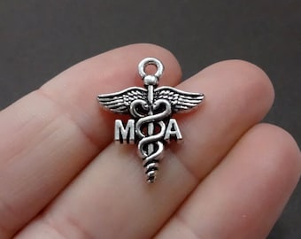 May include: Silver charm with a medical caduceus symbol and the letters "M.O.A."