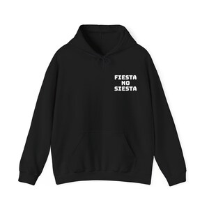 May include: Black hooded sweatshirt with a front pocket and drawstring. The white text "FIESTA NO SIESTA" is printed on the upper chest. The sweatshirt is a casual garment.